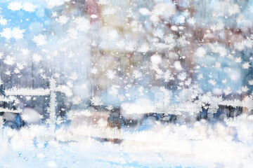 Winter landscape through a frozen window. Blurred snow background. Trees and plants covered with snow.