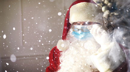 Santa Claus and christmas tree on a background, wearing a protective mask. Coronavirus Christmas....