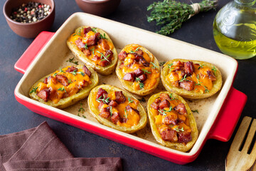 Baked potatoes with bacon, cheese and thyme. Homemade food.