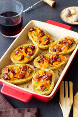 Baked potatoes with bacon, cheese and thyme. Homemade food.