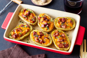 Baked potatoes with bacon, cheese and thyme. Homemade food.