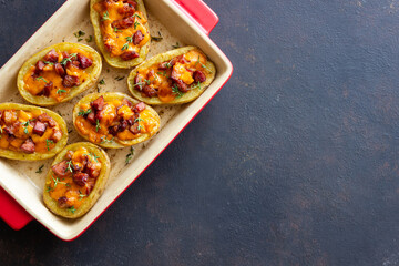 Baked potatoes with bacon, cheese and thyme. Homemade food.