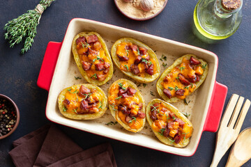 Baked potatoes with bacon, cheese and thyme. Homemade food.