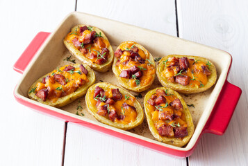 Baked potatoes with bacon, cheese and thyme. Homemade food.
