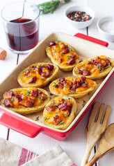 Baked potatoes with bacon, cheese and thyme. Homemade food.