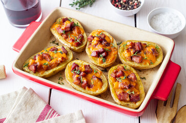 Baked potatoes with bacon, cheese and thyme. Homemade food.