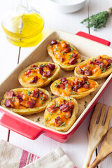 Baked potatoes with bacon, cheese and thyme. Homemade food.