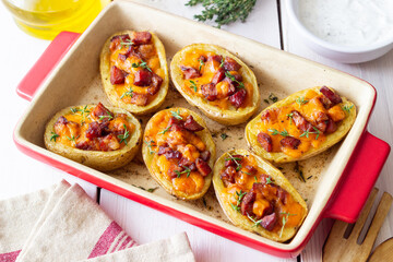 Baked potatoes with bacon, cheese and thyme. Homemade food.