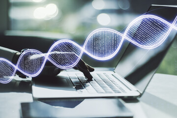 Creative concept with DNA symbol illustration and hands typing on laptop on background. Genome...