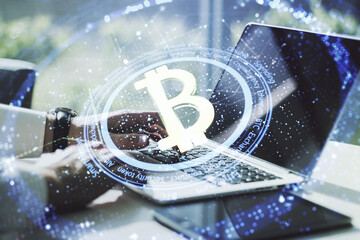 Creative Bitcoin concept with hands typing on computer keyboard on background. Double exposure