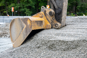 A pile of gravel with a tractor shovel