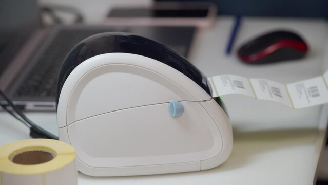 woman uses thermal shipping barcode label printer to print labels