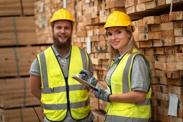 Portrait Caucasian business woman holding clipboard with stock timber and buddy background at wood factory	