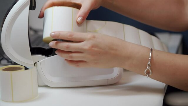 woman uses thermal shipping barcode label printer to print labels