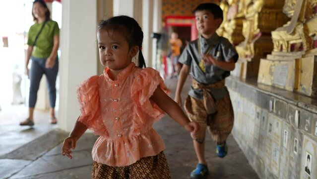 Adorable little boy and girl kid enjoying travelin budddhist temple Wat Arun Bangkok Thailand