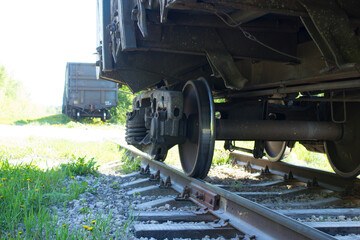 The wheels of the gondola car are on the rails.