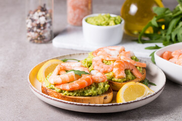 Shrimps on toast with avocado and lemon. Prawns. Breakfast concept. Bruschetta. 