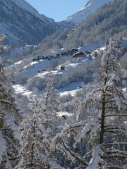 Small mountain village covered in snow in the Swiss Alps - 677743087