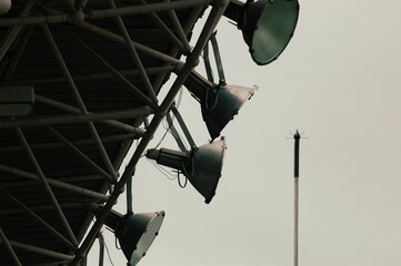 Closeup shot of stadium lights against a cloudy sky