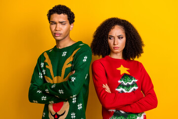 Photo of stressed depressed guy girl dressed christmas ugly print pullovers dislike outfits isolated yellow color background