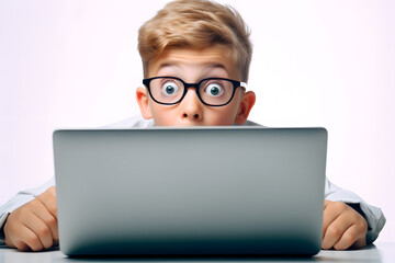 Small kid boy surprised or shocked looking at laptop screen  isolated on white background