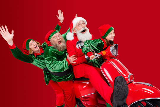 Profile photo of crazy team four people ride moped have party fun wear santa elf costume isolated grey color background