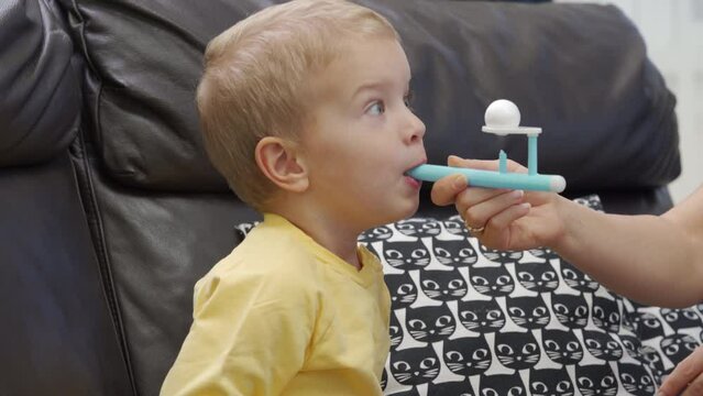 Breathing game for children, floating ball game helps toddler child practicing breathing exercises