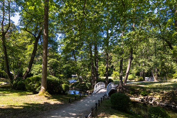 A little romantic bridge in a city park made of wood, painted in white. Park in natural light, on a...
