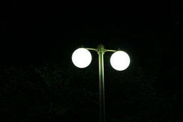 Closeup shot of a street lamp with round lights during nighttime