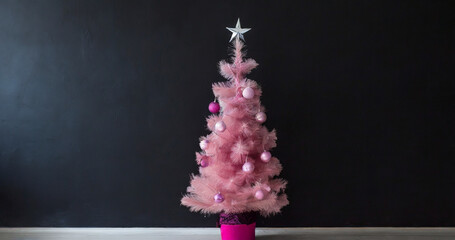 Christmas tree decorated with pink balls and a silver star on a black background