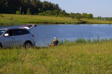 Fototapeta premium A fisherman on the river bank.
