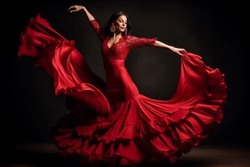 Fotobehang Young woman dancing flamenco on dark background in studio © Adin