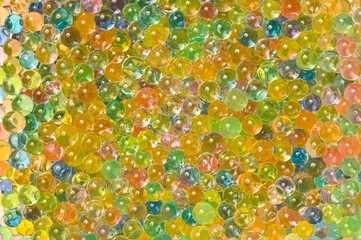 Background of multicolored balls. Expandable water toy orbiz. Flat lay.