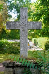 Vertical shot of a granite stone cross in a park