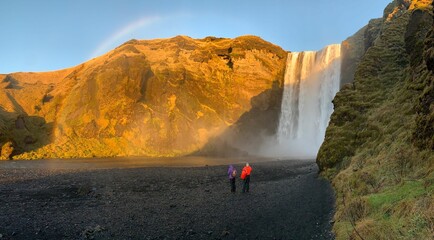 Scenic shot of the Skogafoss waterfall in Iceland with tourists in front of it