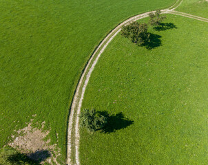 Aerial view of countryside landscape with path through farming fields.
