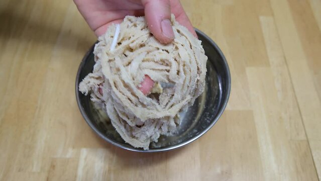 Dry and salted natural sausage casings placed in bowl for washing and rehydration process before being use for stuffing.