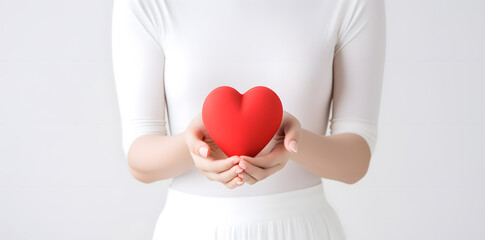 Female hand holding red heart isolated on white background 