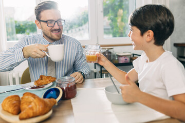 Father and son enjoying breakfast together.