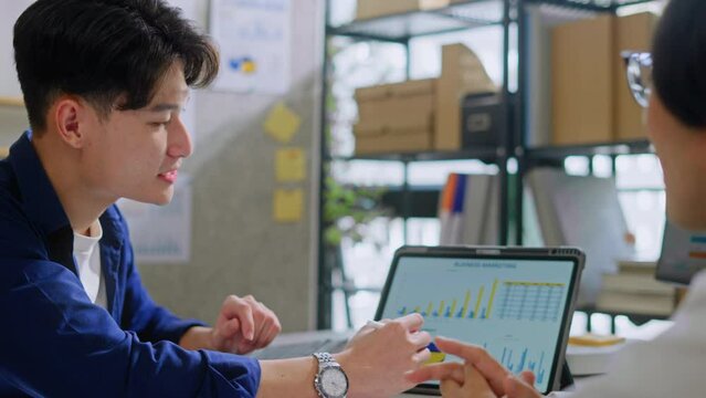 young asian businessman presentation with digital tablet to a Manager in company office.Teamwork,collaboration and brainstorming,strategy and goal,mentor coach,worker learn new skills in office.