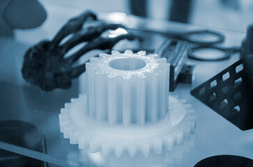 Part detail printed on 3D printer from molten plastic white color. Model of part created on 3D printer from white plastic. Concept 3D printer 3D printing modeling prototyping three dimensional object