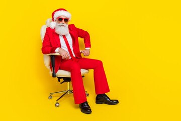 Full size portrait of successful rich aged person sit chair wear luxury outfit isolated on yellow...