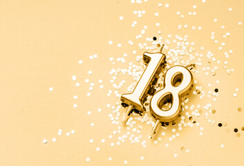 18 years birthday celebration festive background made with golden candle in the form of number...