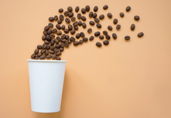 Paper cup and coffee beans. Modern art concept.