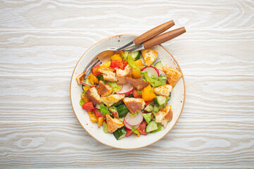 Traditional Levant dish Fattoush salad, Arab cuisine, with pita bread croutons, vegetables, herbs....