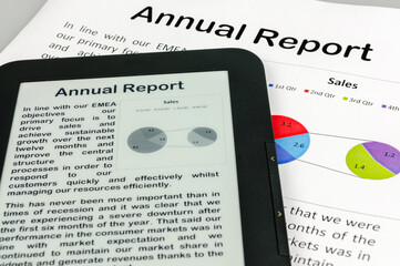 E-reader showing a company annual report with a printed copy