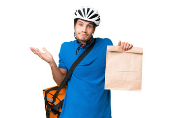 Young caucasian man taking a bag of takeaway food over isolated background having doubts while...