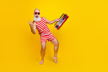 Full length photo of aged man in swimsuit positive singing metal rock roll brutal music holding...