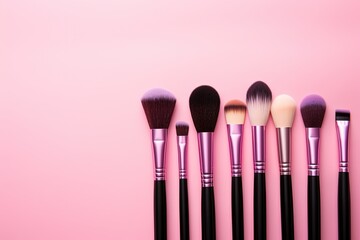 Assorted Makeup Brushes on Soft Pink Background - obrazy, fototapety, plakaty
