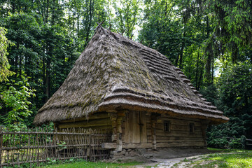 Fototapeta na wymiar An old wooden house under a thatched roof in Lviv's Skansen neighborhood